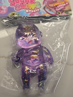 6 Inch Sugar Swaps Orb Glittery Purple Baby Doll Onesie Figurine